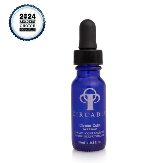 Chrono-Calm Serum in a blue glass bottle with dropper, soothing irritated skin and reducing redness.