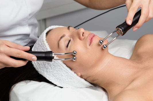 Woman receiving microcurrent facial therapy for skin lifting and toning