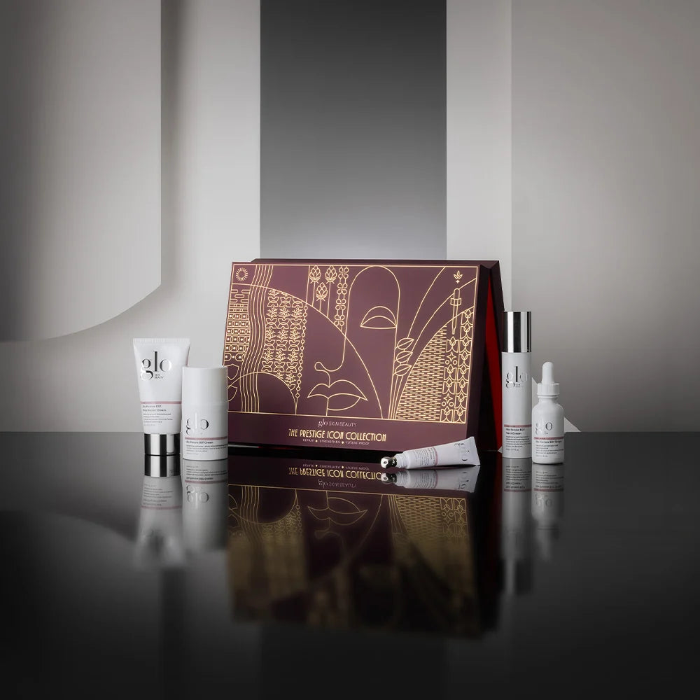 The Prestige Icon Collection featuring five full-size skincare products on a reflective surface.