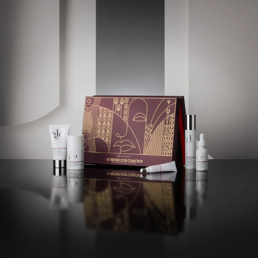 The Prestige Icon Collection featuring five full-size skincare products on a reflective surface.