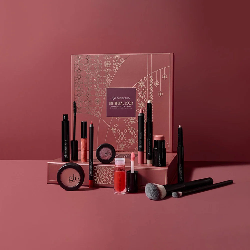 The Reveal Icon beauty gift set featuring mineral makeup and brushes on a stylish backdrop.