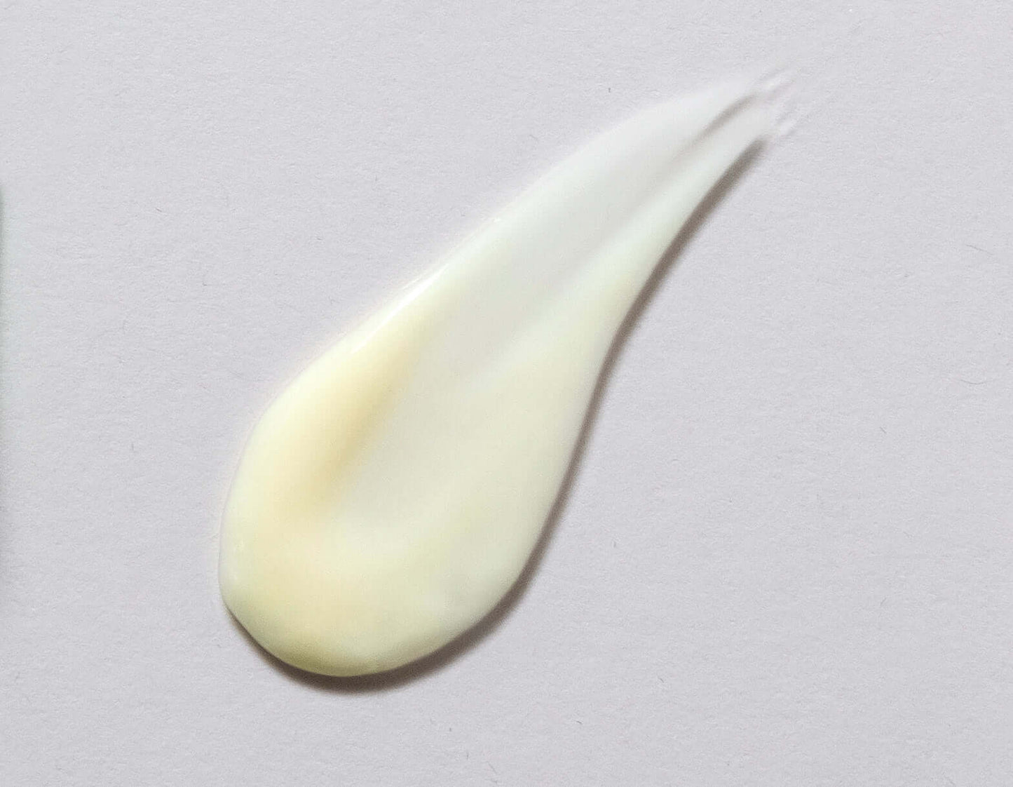 Swatch of Citrus-C Nourishing Cream vitamin C skin cream showing its hydrating and gentle creamy texture on a gray background