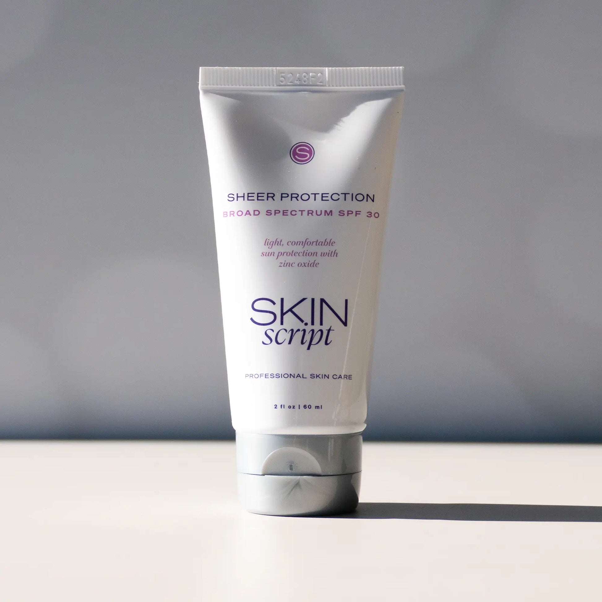  Sheer Protection SPF 30 mineral sunscreen in a white tube with a smooth, matte finish and skin-soothing properties, ideal for daily wear.