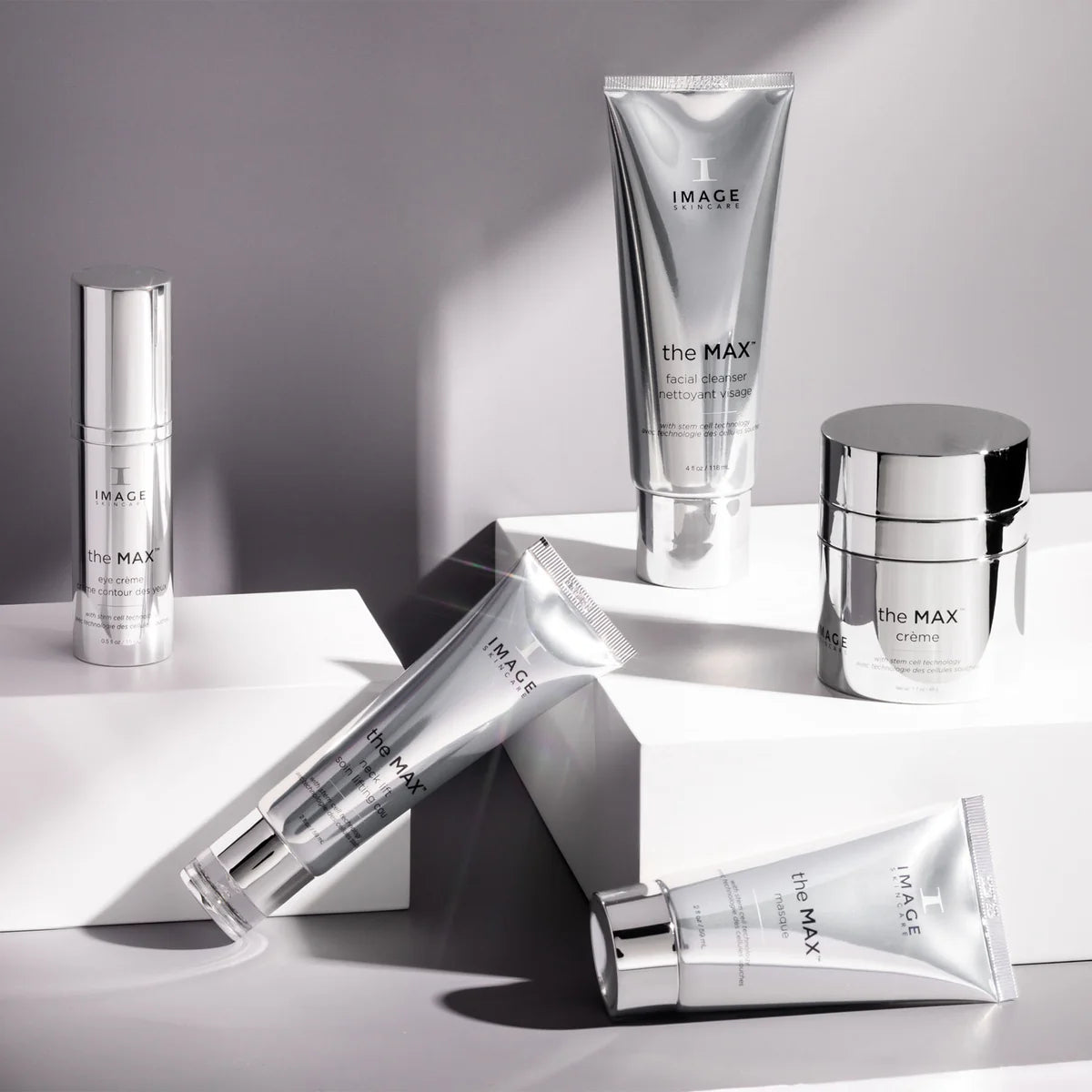the MAX™ crème and other IMAGE skincare products displayed on geometric pedestals in a modern setting.
