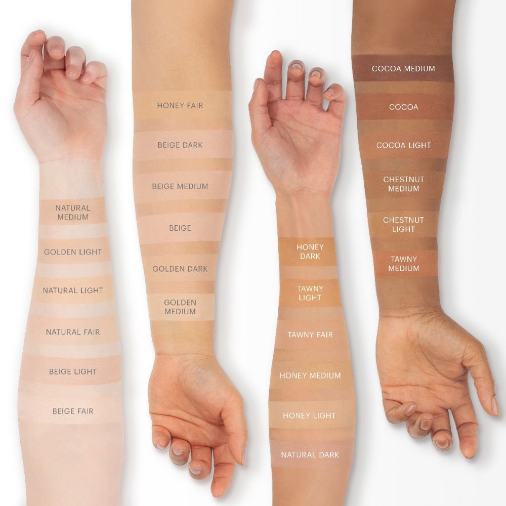 Various shades of pressed powder foundation swatched on different skin tones, showcasing the flexible, weightless, longwearing coverage.