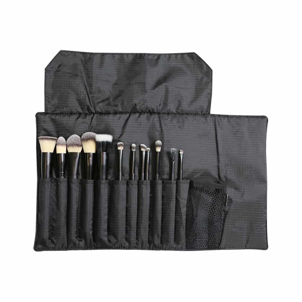 Open brush roll with 11 makeup brushes and flexible mesh pocket, perfect for travel and on-the-go professionals.