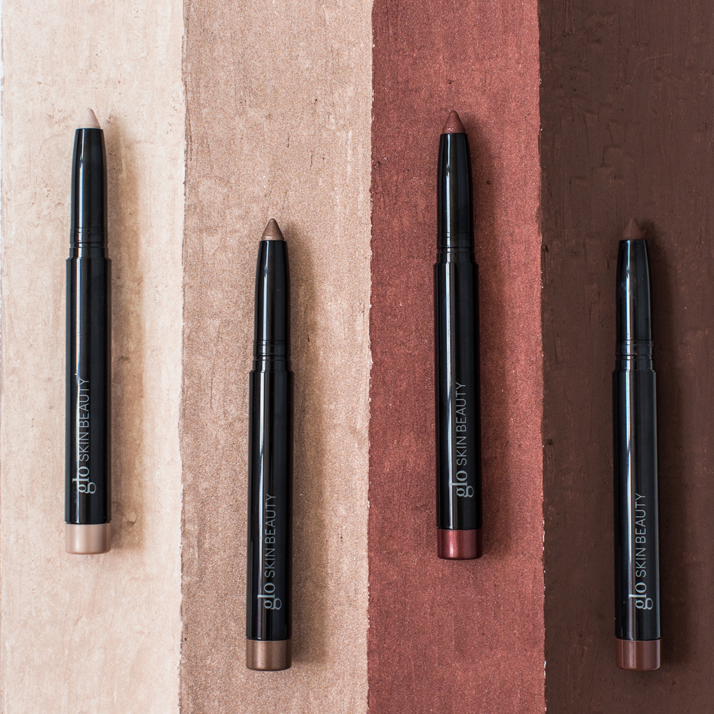 Four Cream Stay Shadow Sticks in varying shades displayed on textured backgrounds for longwear, multi-use application.