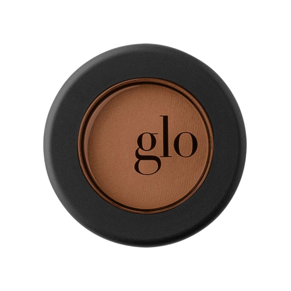 Single mineral eyeshadow in brown shade, velvety and rich-pigment, encased in a black round container with "glo" branding.