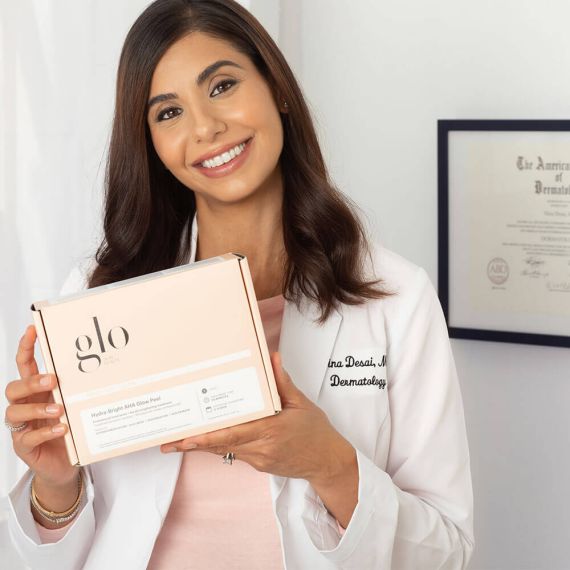 Dermatologist holding Hydra-Bright AHA Glow Peel kit in a clinic setting