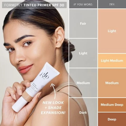 Woman holding Oil-Free Tinted Primer SPF 30, showcasing new shades for different skin tones, including fair, light, medium, and dark.