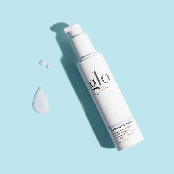 Oil Control Emulsion moisturizer with hyaluronic acid and probiotics for lightweight hydration, shown with product texture on a light blue background.