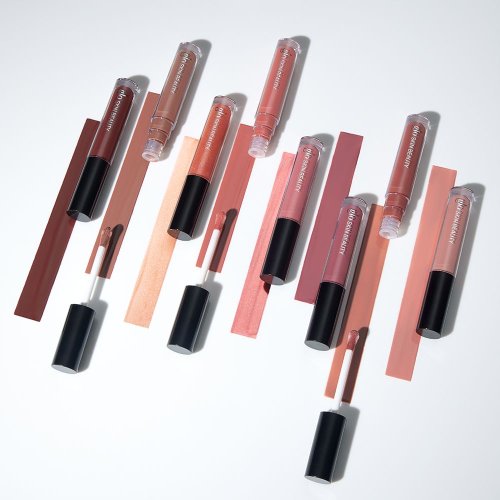 Conditioning lip glosses with high-shine finish, enriched with hyaluronic acid and antioxidants, shown with various color swatches.