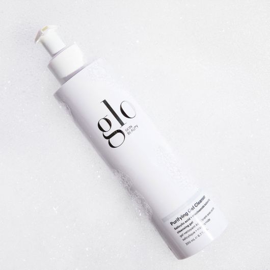 Glo Purifying Gel Cleanser with salicylic acid and niacinamide for skin balancing and exfoliation in a white pump bottle.