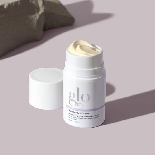 Restorative Cream in white bottle with open lid, featuring rich, nourishing formula for deep moisturization of dry, dehydrated skin